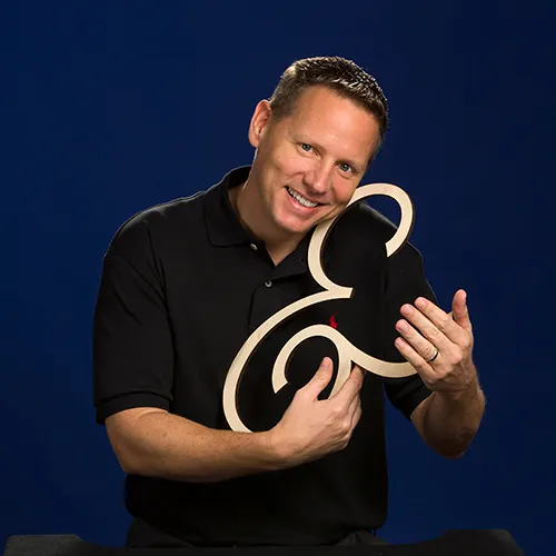chuck norman, s&a communications owner, with ampersand symbol